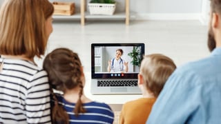 Family watching computer screen